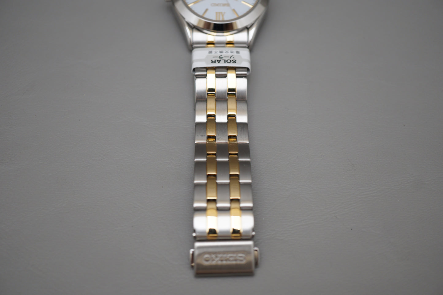 Unworn Seiko Selection SBPX085 V158 Gold Two Tone White Dial Solar Quartz Watch