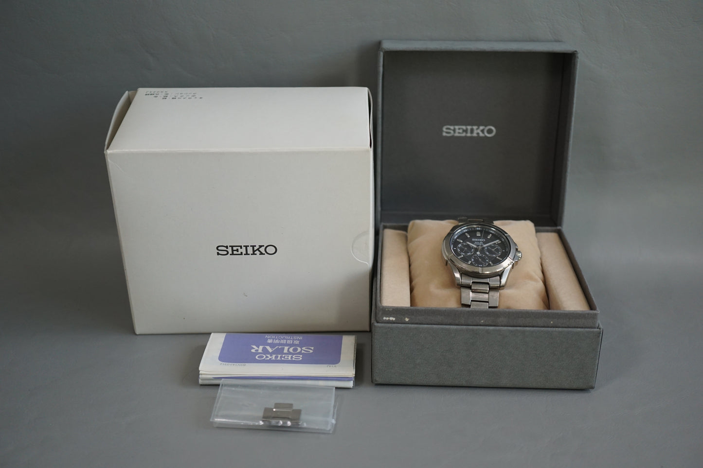 Seiko V14J-0AE0 Titanium Day Date Solar Quartz Watch